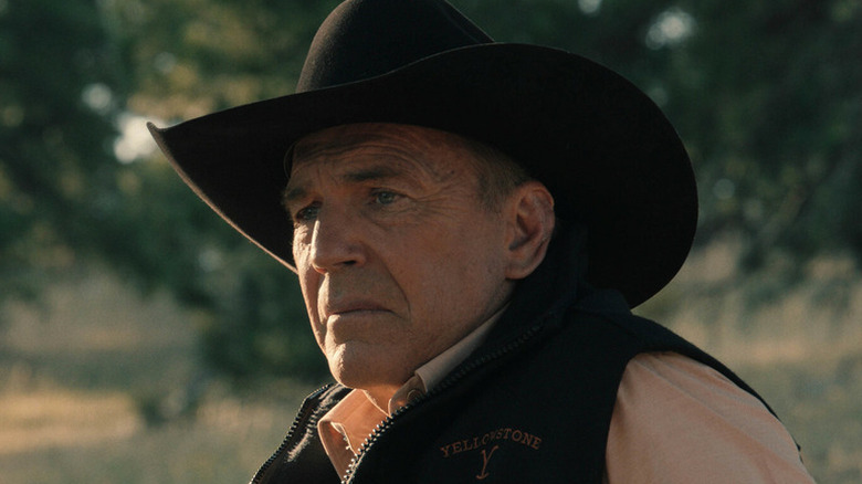 John Dutton (Kevin Costner) sits forlornly in a field in Yellowstone