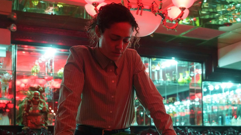 Emmy Rossum as Alice Black in a store lit by red and green lights in Furious