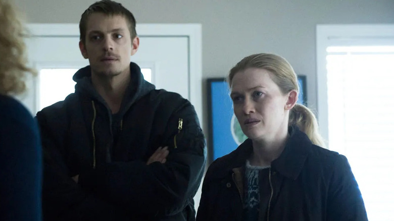 Joel Kinnaman and Mireille Enos as Stephen and Sarah looking at someone in The Killing