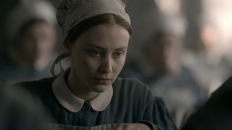 Sarah Gadon as Grace Marks wearing white cap and collared dress in Alias Grace