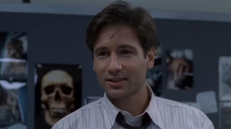 Fox Mulder (David Duchovny) greeting Scully when she first visits his office in The X-Files