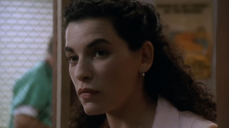 Closeup of Nurse Carol Hathaway (Julianna Margulies) looking down a hallway in ER
