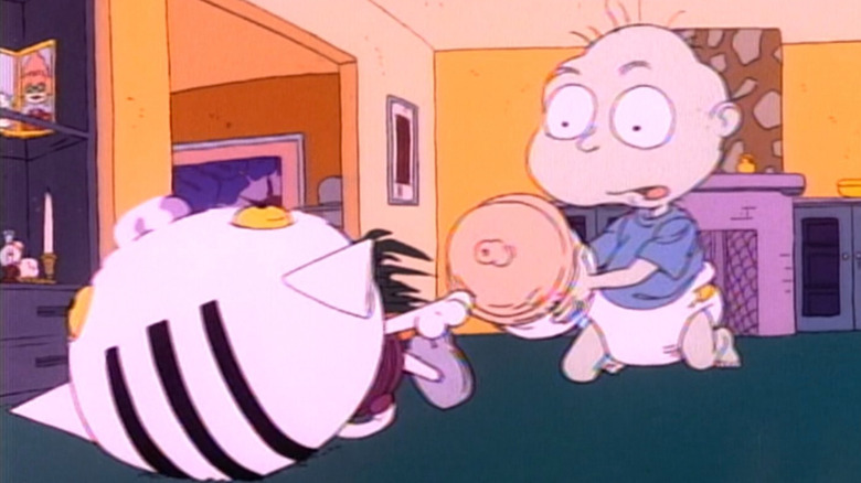 Tommy Pickles looking at cat toy on Rugrats