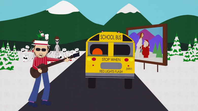 Les Claypool of Primus singing the South Park theme song with aliens in background