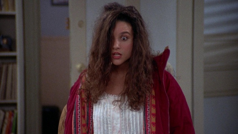 Julia Louis-Dreyfus as Elaine with disheveled hair looking terrified in Seinfeld.