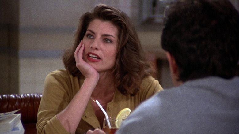 Tracy Kolis as Marlene with resting her head on her hand across from Jerry Seinfeld as Jerry Seinfeld in Seinfeld.