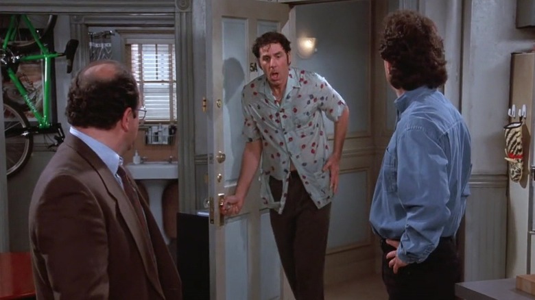 Jason Alexander and Jerry Seinfeld as George and Jerry looking at Michael Richards as a soaking wet Kramer walking into Jerry's apartment in Seinfeld.