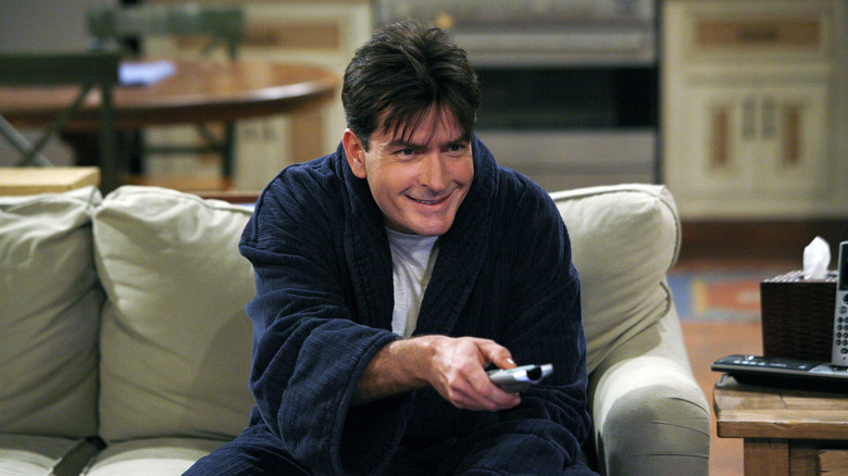 Charlie Harper (Charlie Sheen) eagerly uses a remote control in Two and a Half Men