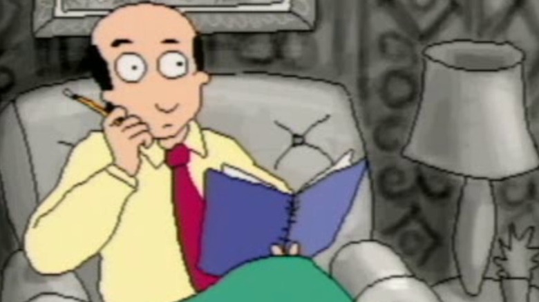 Dr. Katz sitting in his chair and holding a notebook on Dr. Katz, Professional Therapist S1E5