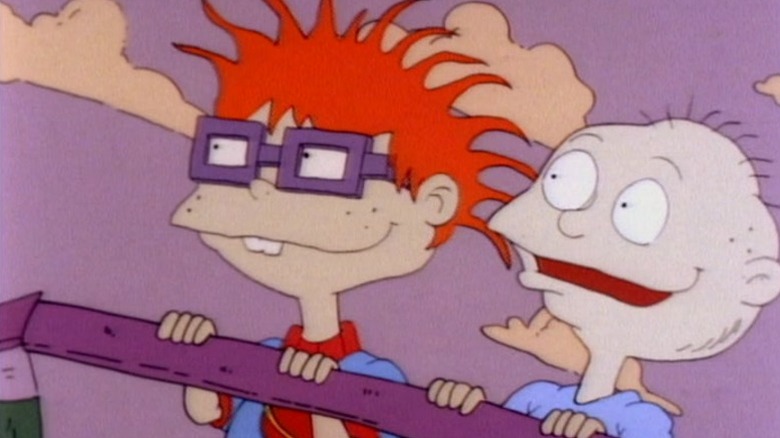 Tommy and Chucking standing inside a crib and smiling on Rugrats S1E7
