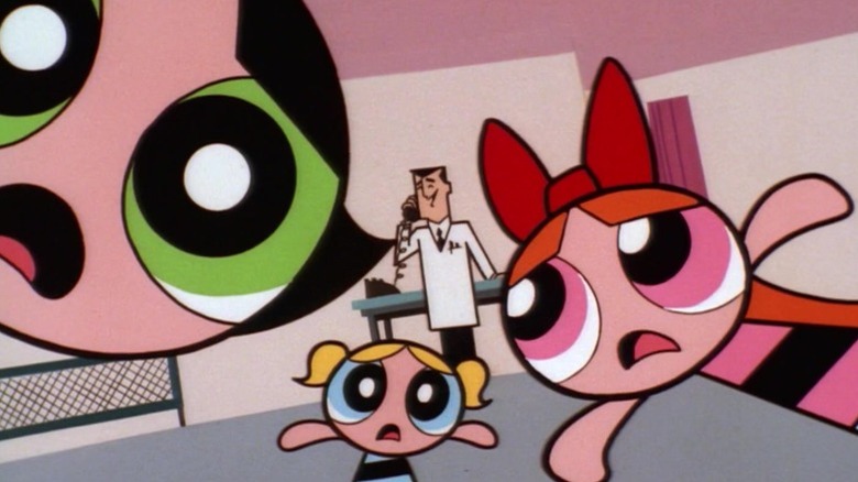 Buttercup, Bubbles, and Blossom standing in shock around Professor Utonium while he talks on the phone on The Powerpuff Girls S1E6