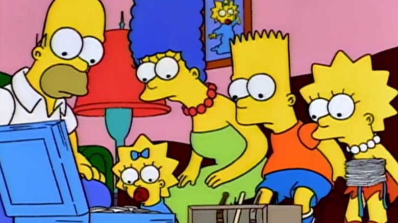 Homer, Maggie, Marge, Bart, and Lisa looking at a box of silver dollars on The Simpsons S5E14