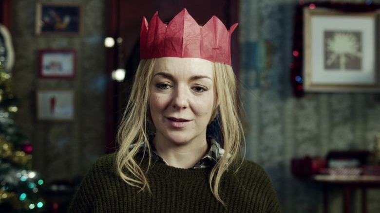 Christine wearing a paper crown and looking down on Inside No. 9 S2E2