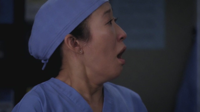 Cristina (Sandra Oh) looking to the side and gasping in horror on Grey's Anatomy