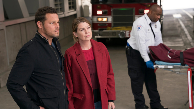 Alex (Justin Chambers) and Meredith (Ellen Pompeo) looking confused at patients in the ambulance bay on Grey's Anatomy