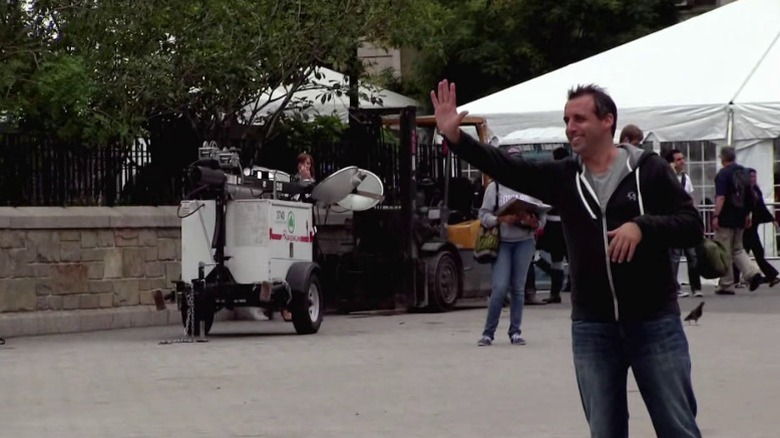 Joe offering a high-five on the street on Impractical Jokers S2E5