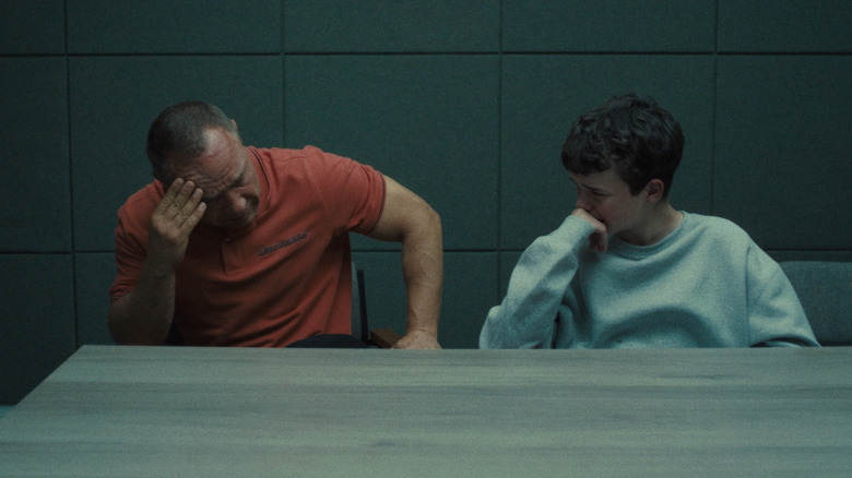 Eddie and Jamie Miller sit at a table and are upset in Adolescence.