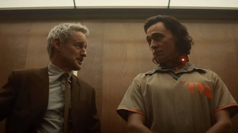 Owen Wilson as Mobius looking at Tom Hiddleston as Loki in a TVA jumpsuit in Loki