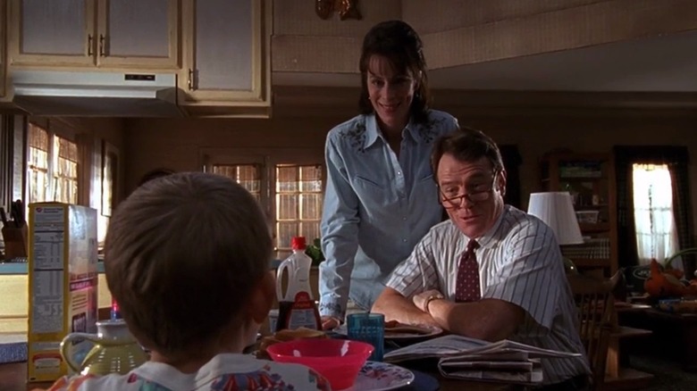Jane Kaczmarek as Lois standing and Bryan Cranston as Hal sitting across from Erik Per Sullivan as Dewey in Malcolm in the Middle