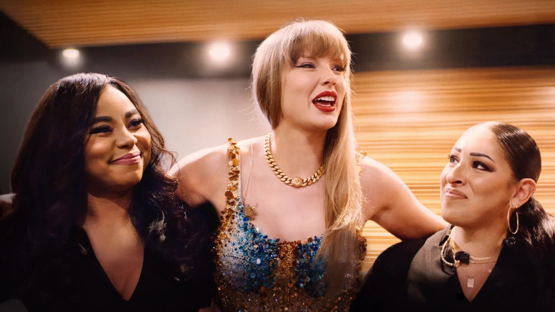 Taylor Swift hugging Elliotte Woodford and Jeslyn Gorman backstage in The End of an Era