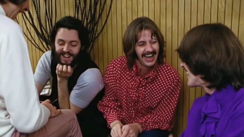 Paul McCartney, Ringo Starr, and George Harrison laughing in a studio in The Beatles: Get Back
