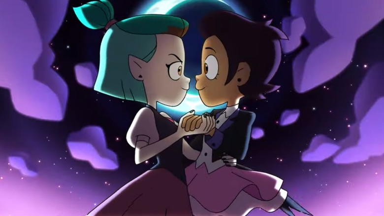 Amity and Luz dancing in front of a crescent moon in The Owl House