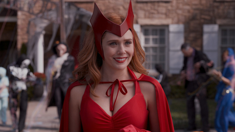 Elizabeth Olsen as Wanda Maximoff smiling in a Scarlet Witch Halloween costume in WandaVision