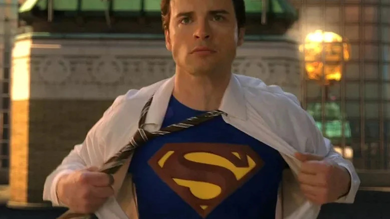 Clark Kent taking off his shirt to reveal Superman costume
