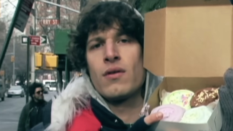 Andy Samberg holding up a box of cupcakes in Lazy Sunday on SNL