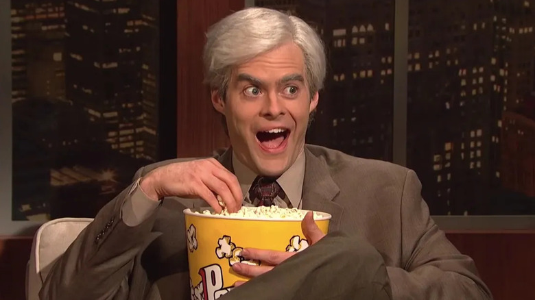Bill Hader as Keith Morrison smiling and eating popcorn on SNL