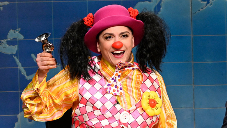 Cecily Strong as Goober the Clown honking a horn during Weekend Update on SNL