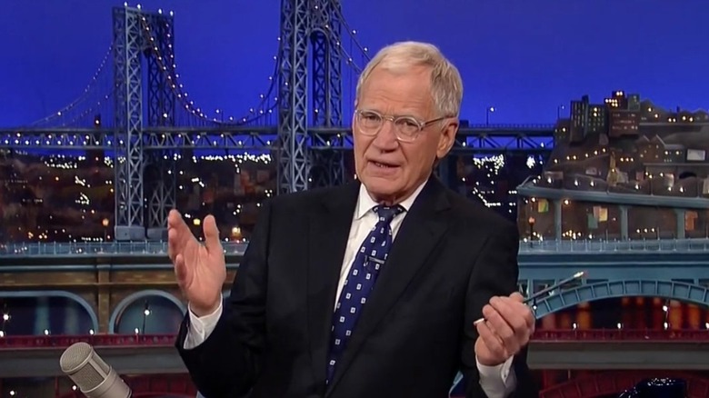 David Letterman sitting at The Late Show desk talking in 2015