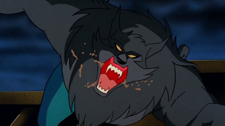 A large black werewolf is screaming at the camera with spit flowing from its jaws