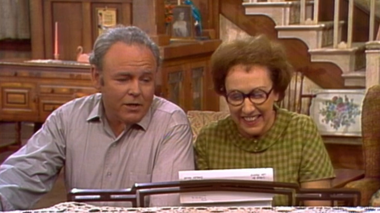 Archie and Edith Bunker singing at piano