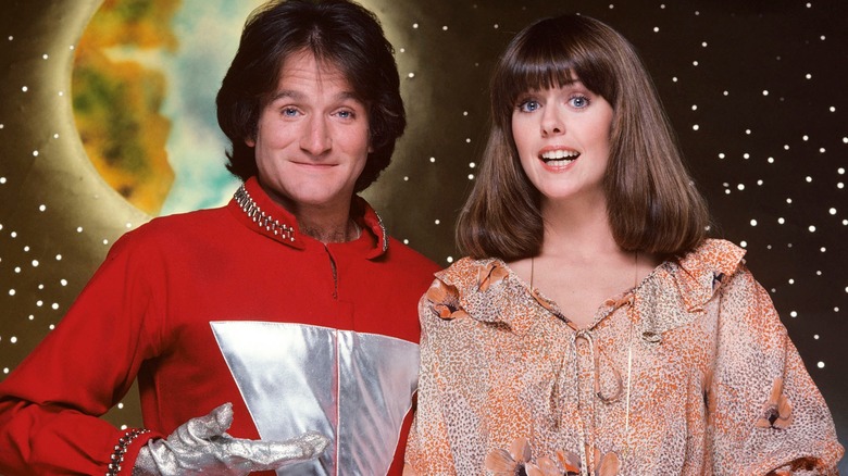 Mork presenting Mindy against a space backdrop