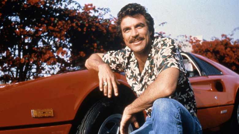 Tom Selleck poses by a Ferrari