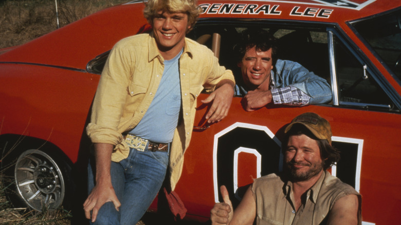Vance, Bo, and Cooter pose with the General Lee