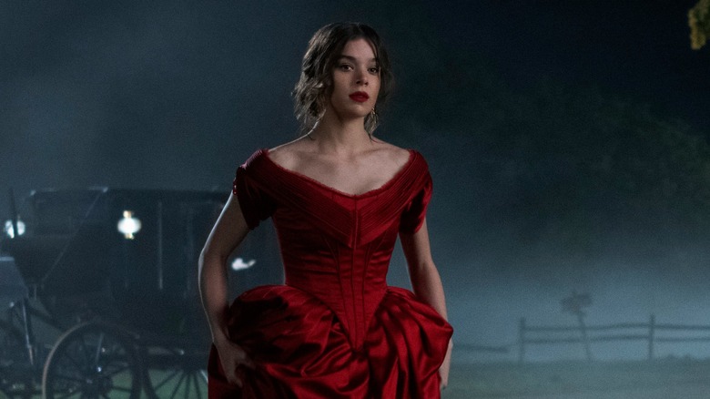 Emily Dickinson stands in a red dress in a misty field in "Dickinson" Season 1.