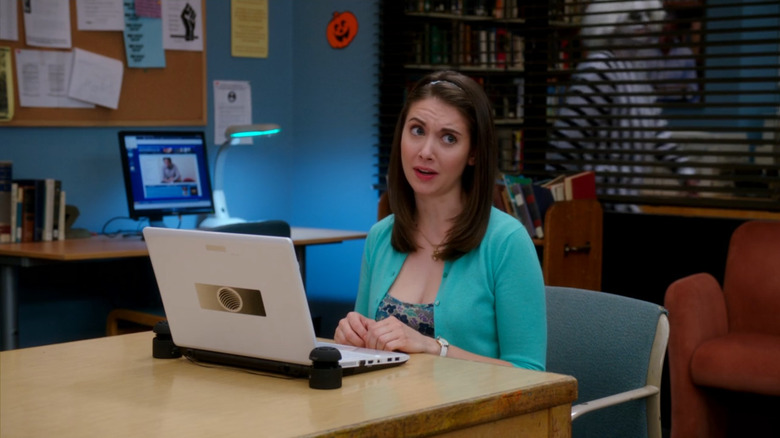 a student in a Beetlejuice costume walks past Annie in "Community" (2009)