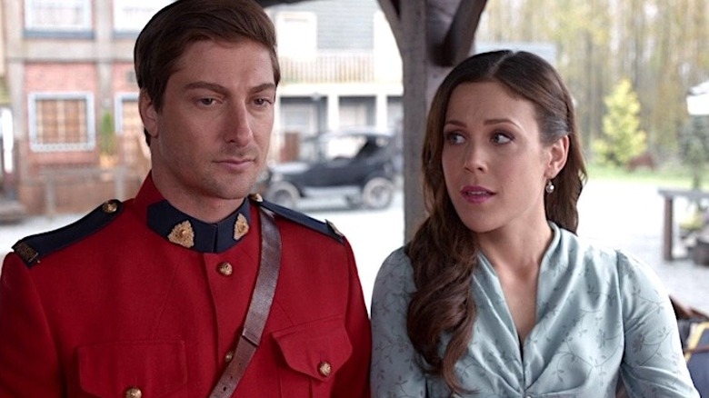 Jack in a red outfit and Elizabeth in a blue dress in When Calls the Heart