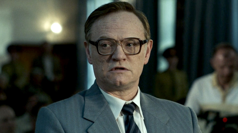 Valery Legasov standing in a room with glasses on in Chernobyl