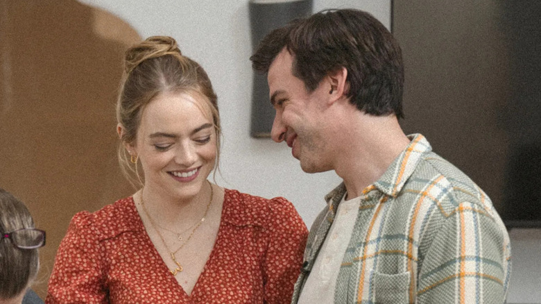 Asher looking at Whitney, who is looking down, as they both smile on The Curse episode "Green Queen"