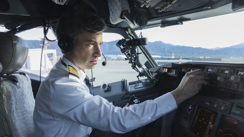 Nathan Fielder adjusting controls in an aircraft cockpit on The Rehearsal episode "My Controls"