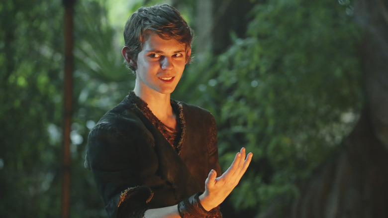 Peter Pan grinning and raising his hand in Once Upon a Time.