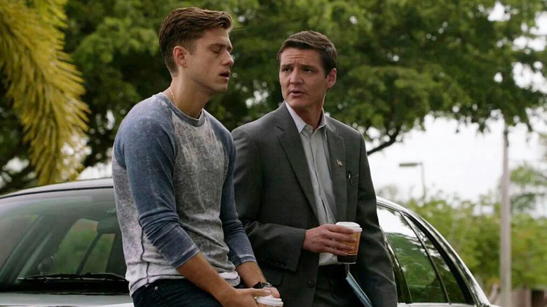 Juan Badillo talking to Mike Warren while leaning on a car in Graceland (2013)