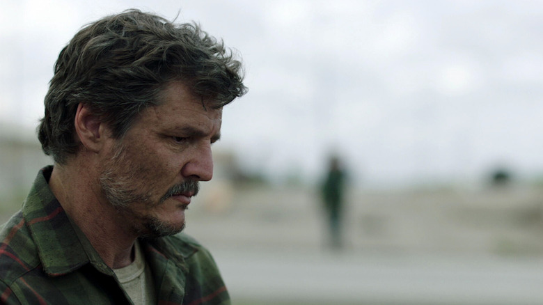 Joel staring down at the ground with a somber expression in The Last of Us (2023)