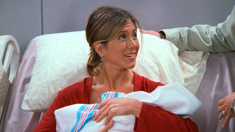 Rachel holding her newborn baby in Friends