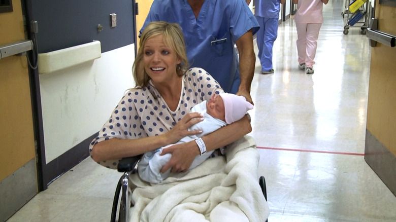 Dee holding her surrogate baby in It's Always Sunny in Philadelphia