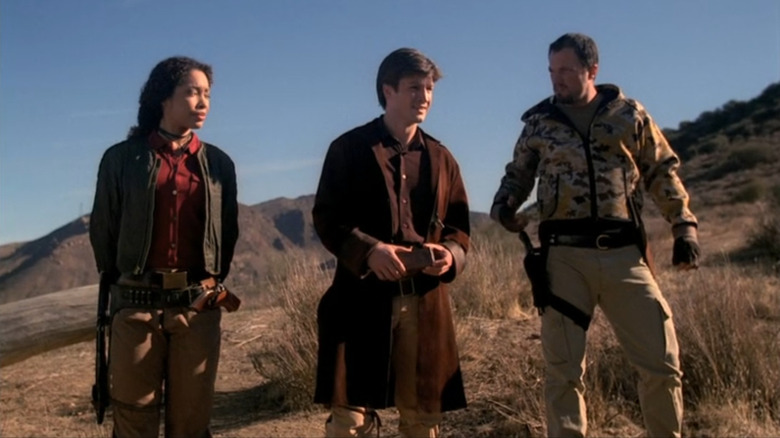 Mal, Zoe and Jayne standing on a hill in Firefly (2002)