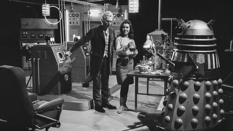 The Doctor inspecting a Dalek from the original 1960s "Doctor Who" series